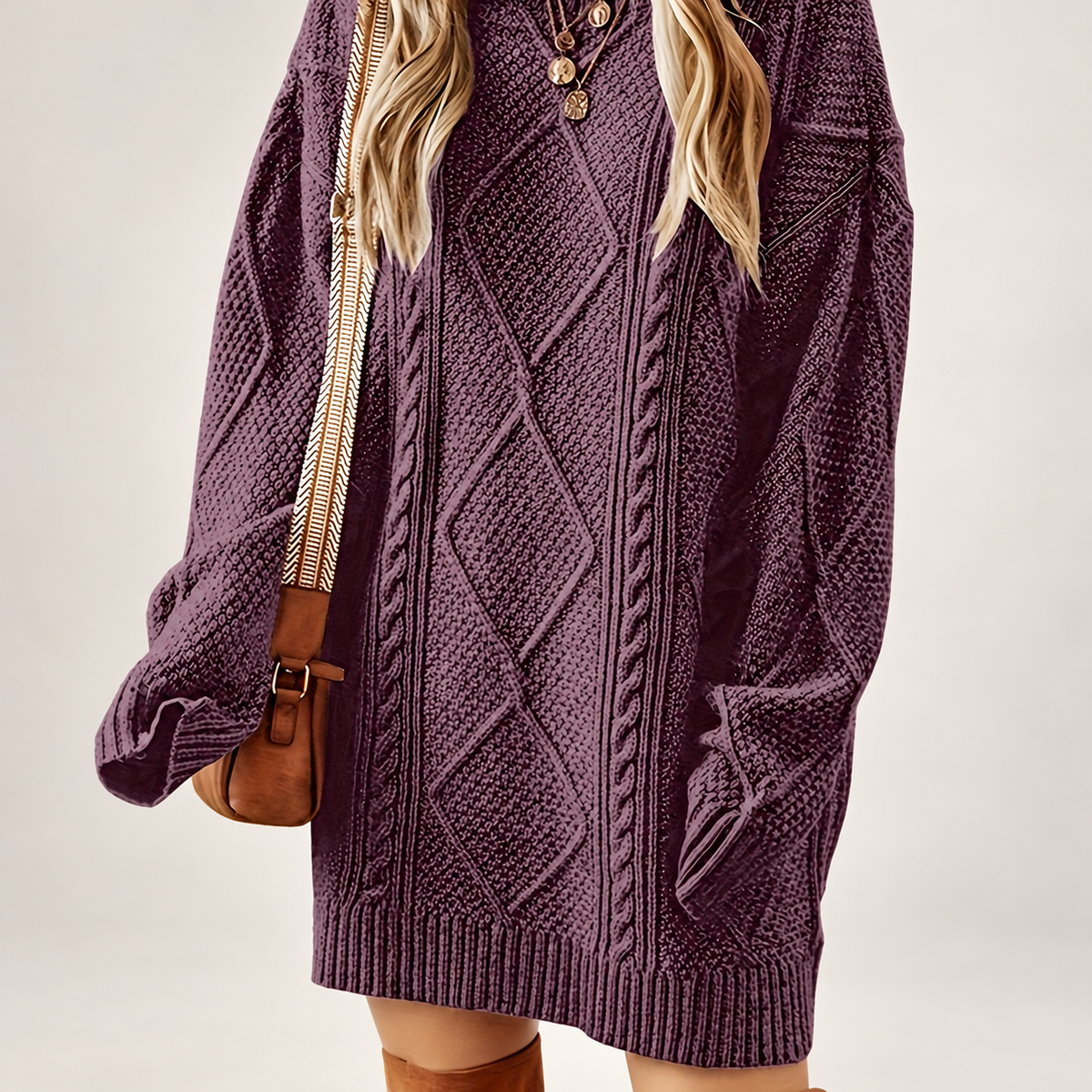 Women's cable-textured sweater dress on a light neutral background