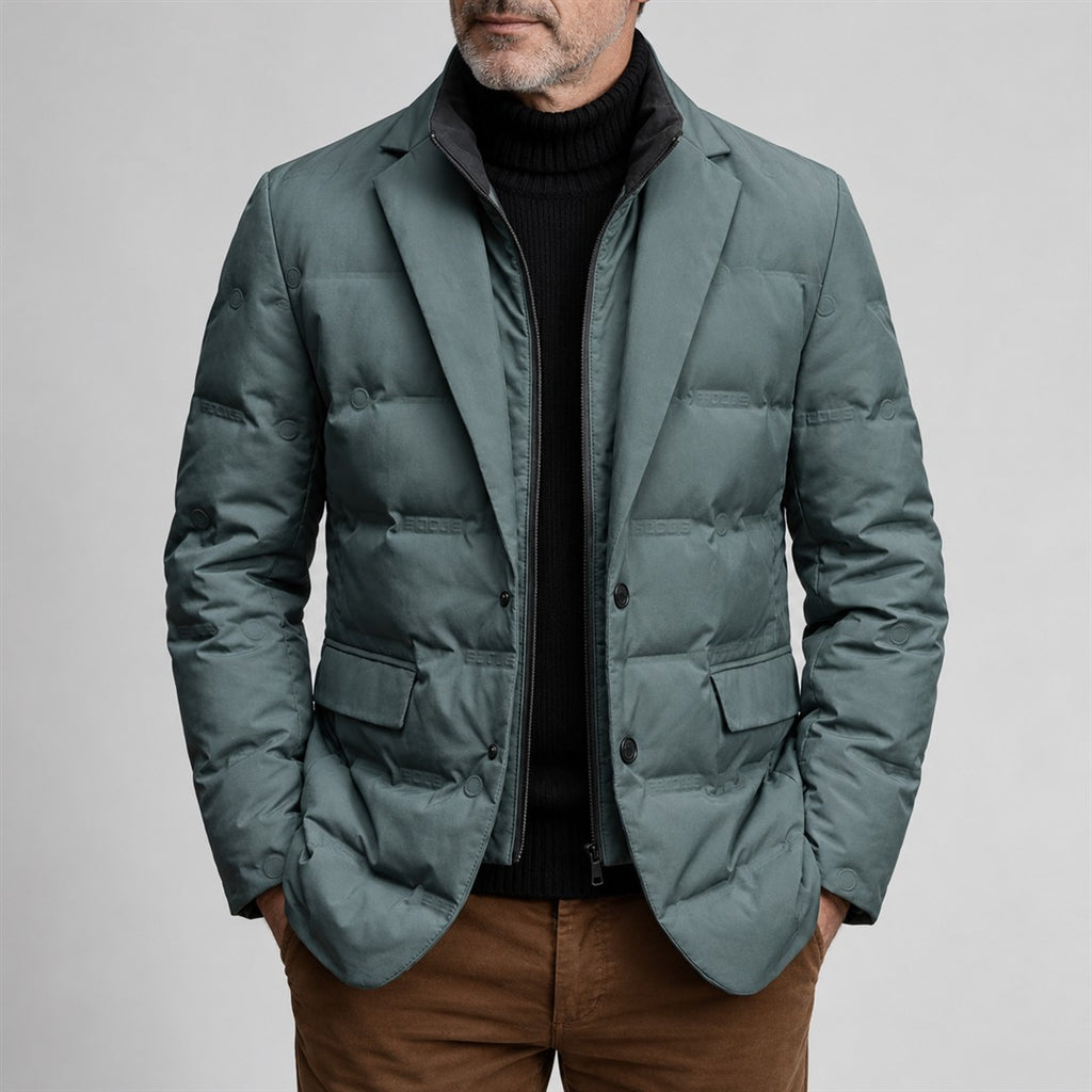 Teal-grey quilted jacket with lapels worn by a mature man against a light grey background