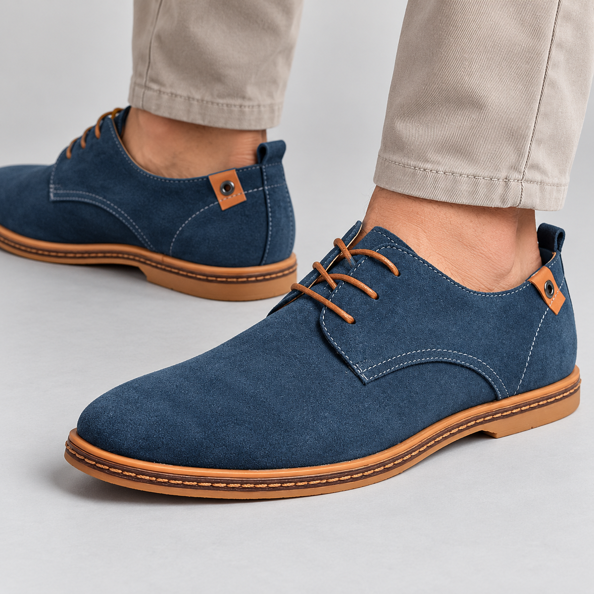 Men's blue suede derby shoes with lace-up front and tan sole